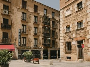 a large brick building with a sign on it at Sercotel Toledo Imperial in Toledo