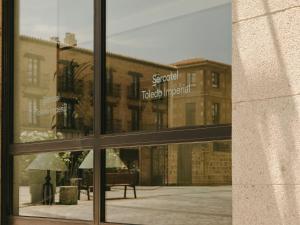 a reflection of a building in a window at Sercotel Toledo Imperial in Toledo
