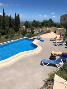 a swimming pool with lounge chairs and a swimming pool at Gîte Apaisant in Llauro