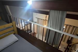 a room with a balcony with a bed and a window at Chalé Private c/ Vista e garagem in Ilhabela