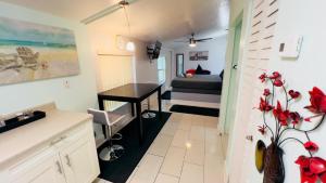 a small room with a bed and a desk at Billy's Resort- Men Only - Solo Hombres in Wilton Manors