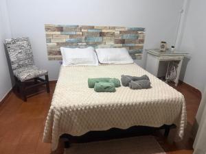 a bedroom with a bed with two pillows on it at Dpto Céntrico con Balcón Dpto 1 in Puerto Iguazú