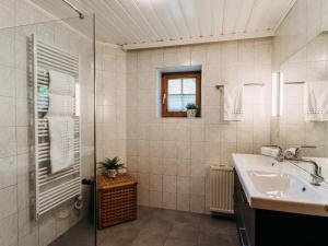 a bathroom with a sink and a glass shower at Barney in Rauris +45 photos