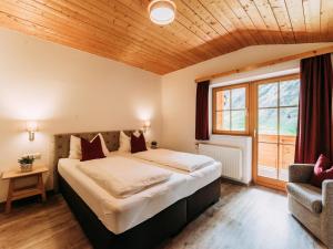 a bedroom with a large bed and a window at Barney in Rauris