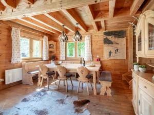 a kitchen with a table and chairs in a room at Waldberg in Krimml