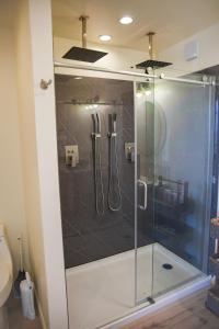 a shower with a glass door in a bathroom at Dome on the Range in Duchesne +5 photos