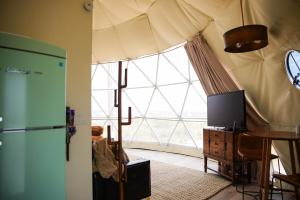 a living room with a large window and a tv at Dome on the Range in Duchesne