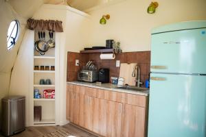 a kitchen with wooden cabinets and a refrigerator at Dome on the Range in Duchesne