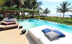a villa with a swimming pool next to a resort at Casa Macagua in El Puertecito
