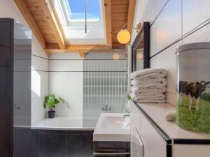 a bathroom with a sink and a shower with a fish tank at Kötschach in Kötschach +34 photos