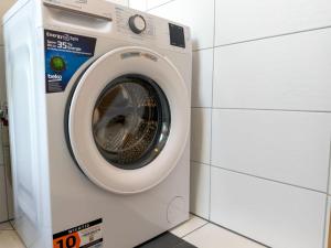 a washing machine is next to a stack of white tiles at Kötschach in Kötschach