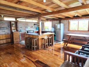 a large kitchen with a counter and a refrigerator at Casas vacacionales Sofioli in Pedernales