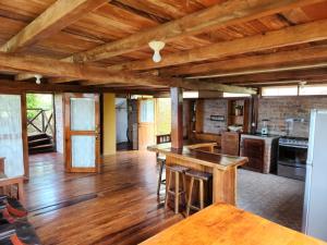 a large kitchen with wooden floors and wooden ceilings at Casas vacacionales Sofioli in Pedernales +19 photos