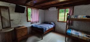 a bedroom with a bed and a sink in a room at Casas vacacionales Sofioli in Pedernales