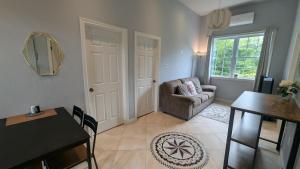 a living room with a table and a chair at Happy Moose Guest Suite in Porters Lake