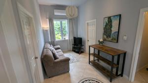 a living room with a couch and a table at Happy Moose Guest Suite in Porters Lake