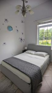 a bedroom with a large bed with a ceiling fan at Happy Moose Guest Suite in Porters Lake