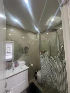 a bathroom with a shower and a toilet and a sink at Beachfront Haven - Perfect for Groups in Ashdod +11 photos