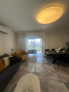 a living room with a couch and a table at Beachfront Haven - Perfect for Groups in Ashdod