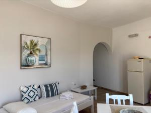 a living room with a couch and a table at Creta Sun Apartments in Makrigialos Sea-view in Makry Gialos +81 photos