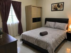 a bedroom with a bed with a brown towel on it at Kalimero Homestay in Pančevo