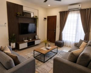 a living room with two couches and a television at Kalimero Homestay in Pančevo