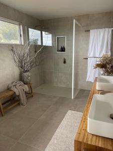 a bathroom with a shower and two sinks and a shower at Travellers Rest Bicheno in Bicheno +25 photos