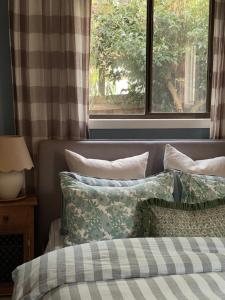 a bedroom with a bed with pillows and a window at Travellers Rest Bicheno in Bicheno