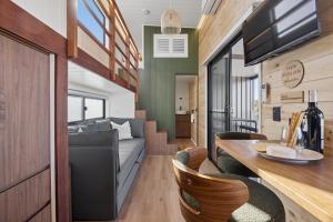 a living room and dining room of a tiny house at Ginger GOAT - Luxury New Tiny Home in Jindabyne