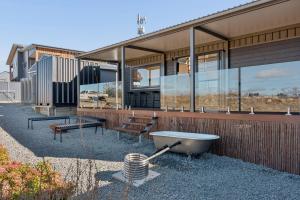 a house with a bath tub on the side of it at Ginger GOAT - Luxury New Tiny Home in Jindabyne