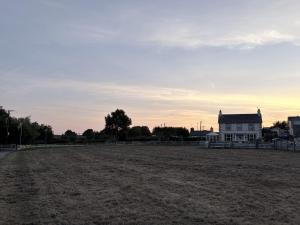 an empty field in front of a house at Taldrwst At Dwyran in Dwyran +8 photos