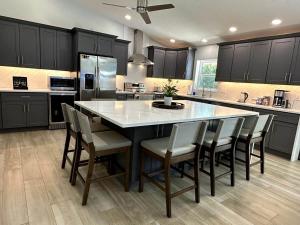 a large kitchen with a large table and chairs at Jupiter Heated Pool/Spa Luxury 3Bed Home in Jupiter