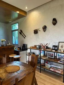 a dining room with a table and a shelf with skulls on the wall at jnan Lemonie in Asilah
