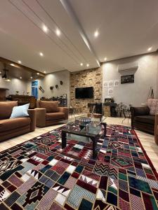 a living room with a large rug on the floor at jnan Lemonie in Asilah