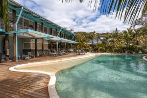 a resort with a swimming pool next to a building at Mobys Resort 08 in Boomerang Beach