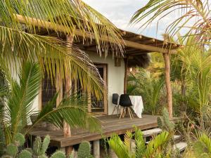 a house with a chair on a wooden deck at Casa Macagua in El Puertecito