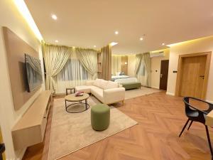 a living room with a couch and a bed at Amazonia Luxury in Abuja