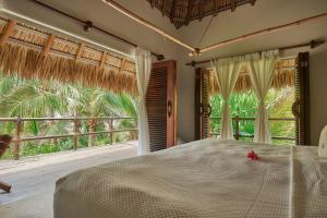 a bedroom with a bed and a large window at Casa Macagua in El Puertecito +122 photos