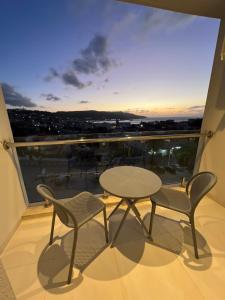 a balcony with a table and chairs and a view at Hotel bouzeriba in El Kala