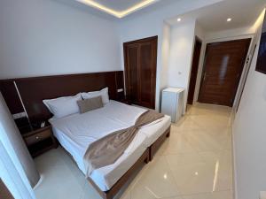 a bedroom with a large bed with a wooden headboard at Hotel bouzeriba in El Kala