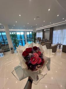 a lobby with a large bouquet of red roses at Hotel bouzeriba in El Kala