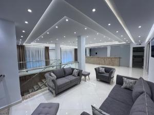 a living room with couches and chairs in a building at Hotel bouzeriba in El Kala