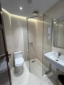 a bathroom with a shower and a toilet and a sink at Hotel bouzeriba in El Kala