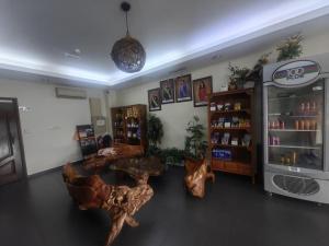 a room with two wooden tables in a store at The Fern Lodge Hotel in Skudai +29 photos