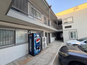 a car parked outside of a building with a vending machine at BELL RESORT MOTEL in Bell
