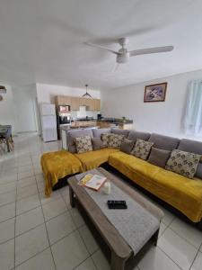 a living room with a couch and a table at La Casa Bongo - T4 cosy en pleine nature in Capesterre-Belle-Eau