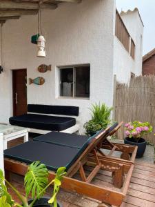 a patio with a table and a bench on a deck at Casa para 6 personas con vista al mar Cumbre del Diablo 3 in Punta Del Diablo