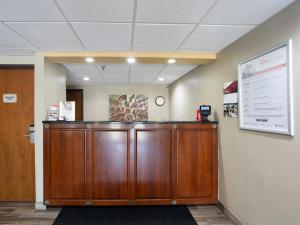 a wooden podium in a office with a sign on a wall at Red Roof Inn Binghamton North in Binghamton