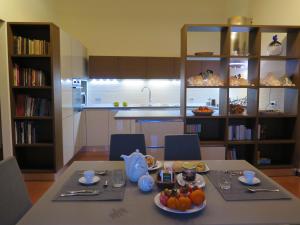 a kitchen with a table with plates of fruit on it at Porta Baciamano in Geraci Siculo