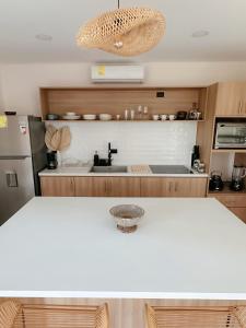 a kitchen with a white counter top and a sink at Casa Tierra Esmeralda in Parrita